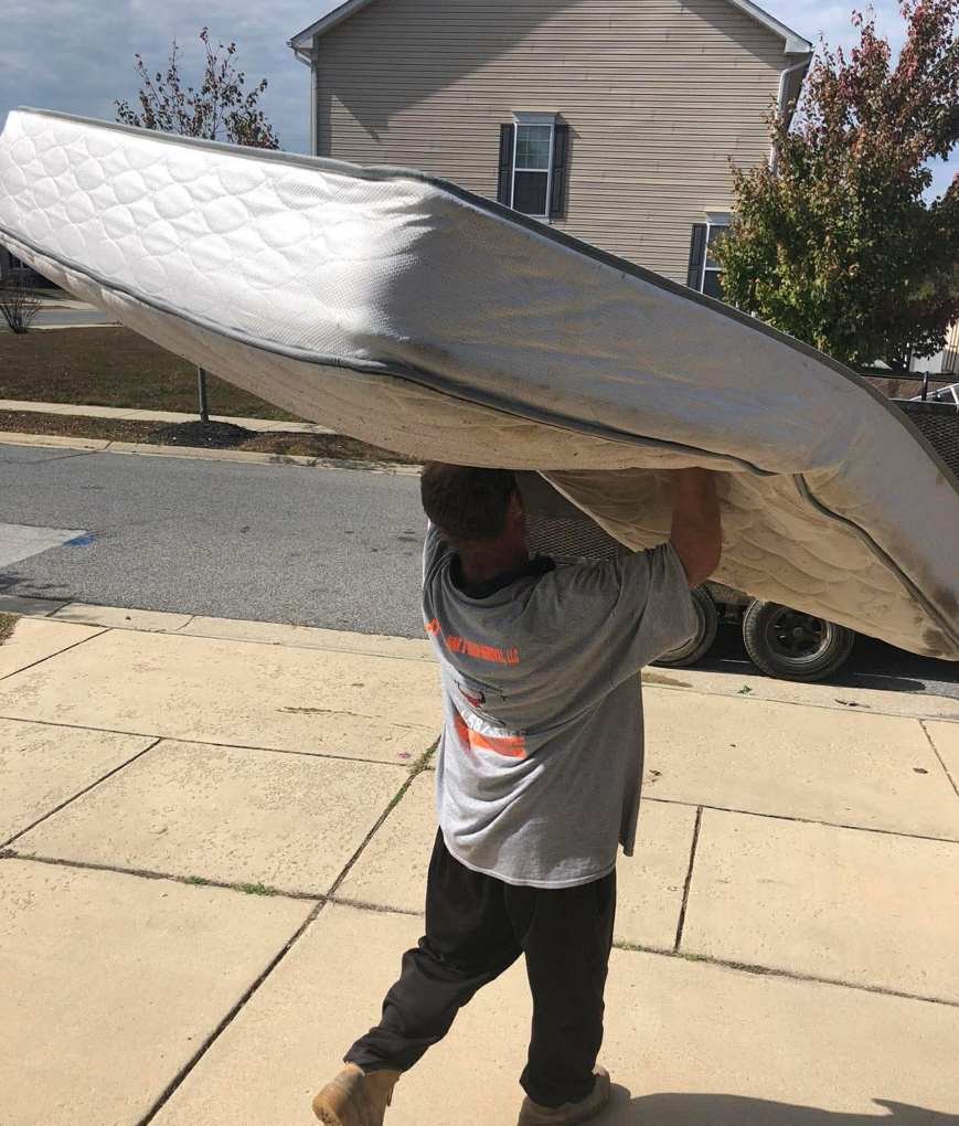 JTs worker carrying a mattress from a Woodbridge homeowner